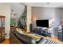 Cozy living room featuring a fireplace, hardwood floors, and comfortable seating area for relaxing at 1270 Taylor Oaks Dr, Roswell, GA 30076