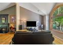 Inviting living room with a fireplace, hardwood floors, and a large window overlooking the greenery at 1270 Taylor Oaks Dr, Roswell, GA 30076