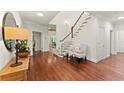 Bright foyer features hardwood floors, staircase with white rails, and detailed trim at 5455 Malone Ct, Powder Springs, GA 30127