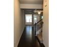 Spacious foyer with hardwood floors, staircase, and view into the living room at 5671 Radford Loop, Fairburn, GA 30213