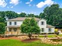 Beautiful two-story home featuring white painted brick, a welcoming front porch, and a serene water feature at 2015 Clipper Straits, Snellville, GA 30078