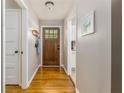 Bright entryway with hardwood floors, coat rack, and view into the kitchen at 2617 Warwick Ne Cir, Atlanta, GA 30345