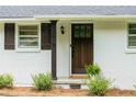 Detailed view of the home's front door, featuring a dark wood finish and modern hardware at 2617 Warwick Ne Cir, Atlanta, GA 30345