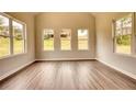 Sun-drenched room featuring wood floors and three windows offering an abundance of natural light at 670 Park Place Way, Social Circle, GA 30025