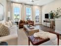 Bright and airy living room with modern decor, hardwood floors, and large windows showcasing the view at 921 Hughley Circle Se # 66, Atlanta, GA 30316