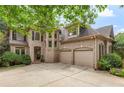 Charming two-story brick home with a well-manicured lawn, a three car garage and an arched entryway at 5355 Highland Pine Ln, Mableton, GA 30126