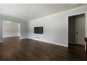 Inviting living room with hardwood floors, gray walls, white trim and a wall-mounted TV at 159 Lloyd Dr, Marietta, GA 30066