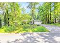 Inviting home nestled in a wooded setting, featuring a charming front exterior and a long, private driveway at 1445 Woodhill Dr, Marietta, GA 30066
