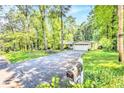 Spacious home with a long driveway and beautiful surrounding greenery, providing a sense of privacy at 1445 Woodhill Dr, Marietta, GA 30066