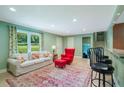 Finished basement featuring a bar with seating, and a cozy living area with tile flooring, perfect for entertaining at 2081 Old Peachtree Road Northeast Rd, Lawrenceville, GA 30043