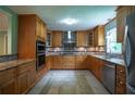 Well-appointed kitchen boasts custom wood cabinets, stainless steel appliances, and granite countertops at 2081 Old Peachtree Road Northeast Rd, Lawrenceville, GA 30043