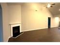 Open living room showcases vaulted ceilings, a fireplace, and hardwood floors at 210 Park Place Trl, Social Circle, GA 30025