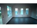 Sunlit living room featuring hardwood floors and multiple windows at 210 Park Place Trl, Social Circle, GA 30025