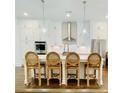 Stylish kitchen island with seating, pendant lights, and modern stainless steel appliances at 130 W Main Street # 1, Buford, GA 30518