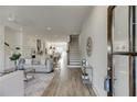 Open-concept living area with hardwood floors, modern lighting, and seamless flow to the kitchen at 130 W Main Street # 1, Buford, GA 30518