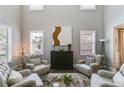 Well-lit living room featuring a soaring ceiling, stylish decor, and comfortable seating at 5473 Heatherbrooke Nw Dr, Acworth, GA 30101