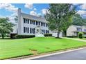 Traditional two-story home with a manicured lawn, complemented by dark shutters and an attached two car garage at 939 Flowers Xing, Lawrenceville, GA 30044