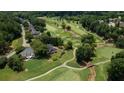 Aerial view of a home on a golf course surrounded by lush greenery and mature trees at 127 Grandmar Chase, Canton, GA 30115