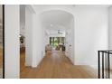 Hallway with hardwood floors, arches, and views into living areas and backyard at 1287 Star Ne Dr, Brookhaven, GA 30319