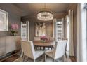 Elegant dining room featuring stylish chandelier, neutral decor, and ample natural light at 49 Conifer Park Ln, Atlanta, GA 30342