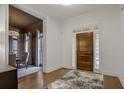 Inviting home foyer with hardwood floors, elegant front door, and adjacent dining area at 49 Conifer Park Ln, Atlanta, GA 30342