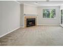 Comfortable living room featuring a cozy fireplace, lots of natural light, and a neutral color scheme at 511 Barrington Hills Dr, Atlanta, GA 30350
