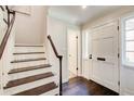 Bright foyer with hardwood floors, staircase, and view to the entry with a white front door at 1105 Clairemont Ave # J, Decatur, GA 30030