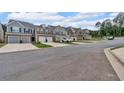 A street view showcasing a row of newly constructed townhomes with two-car garages at 1311 Park Center Cir, Austell, GA 30168