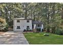 Inviting front exterior of a two-story home with a fresh lawn and mature trees providing privacy at 1770 Austin Dr, Decatur, GA 30032