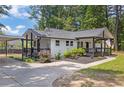 Beautiful renovated home with a welcoming front porch, black and white trim and mature trees at 5601 Due West Rd, Powder Springs, GA 30127