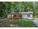 Charming single story home featuring a large yard and lovely covered front porch perfect for relaxing at 995 Highway 101 S, Temple, GA 30179