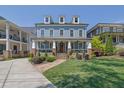 Beautiful two-story blue home featuring a covered porch and well-manicured front lawn, creating an inviting curb appeal at 4256 Weaver Se St, Smyrna, GA 30080