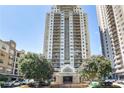 Exterior shot of a tall apartment building with flowering trees in front of it at 795 Hammond Dr # 1012, Atlanta, GA 30328