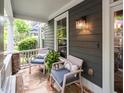 Cozy front porch featuring comfortable seating, stone accents, and a view of the landscaped surroundings at 1622 Gates Nw Pl, Atlanta, GA 30318