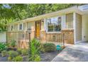 Inviting single-story home with a manicured front yard, brick accents, and covered entryway at 8767 N View Dr, Lithia Springs, GA 30122