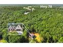 Beautiful wooded acreage surrounding this modern farmhouse-style home near Hwy 78 at 2335 Azalea Dr, Loganville, GA 30052