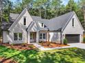 Charming new construction with light brick, lush lawn, and a paved walkway to the front door at 2335 Azalea Dr, Loganville, GA 30052