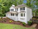 Charming two-story home with white siding, black shutters, and attached two car garage at 3078 Milford Chase Sw, Marietta, GA 30008