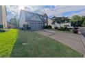Suburban two-story home featuring a two-car garage and well-maintained front yard with a long driveway at 640 Dahoma Trl, Woodstock, GA 30188