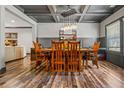Elegant dining room featuring a coffered ceiling, modern chandelier, and hardwood floors at 150 Seals Rd, Dallas, GA 30157