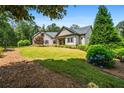 Beautifully landscaped front yard with a two-story home and mature trees at 150 Seals Rd, Dallas, GA 30157