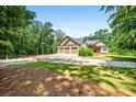 Spacious three-car garage with ample parking on a circular driveway at 150 Seals Rd, Dallas, GA 30157