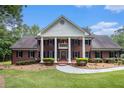 Stately brick home with grand white columns and a well-maintained front lawn at 402 Clyde Ct, Mcdonough, GA 30252