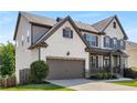 Charming two-story home featuring a brick and siding exterior, well-manicured lawn and a two-car garage at 5240 Bristlecone Pine Way, Cumming, GA 30040