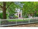 Charming white home surrounded by lush greenery and a white picket fence at 582 Lakeshore Ne Dr, Atlanta, GA 30307