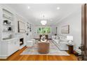 Bright living room features hardwood floors, built-in shelving, fireplace, and neutral decor at 582 Lakeshore Ne Dr, Atlanta, GA 30307