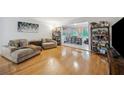 Comfortable living room with wood floors, plush couches, and an open layout to the office at 1468 Briarwood Ne Rd # 406, Brookhaven, GA 30319