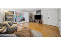 Bright living room featuring wood floors, a TV, and an adjacent office space at 1468 Briarwood Ne Rd # 406, Brookhaven, GA 30319