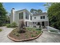 Exterior view of the home with a well-maintained backyard, landscaping, and outdoor seating area at 167 Garden Ln, Decatur, GA 30030