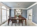 Elegant dining room with large windows, stylish chandelier, and ample natural light at 1777 Water Springs Way, Dacula, GA 30019